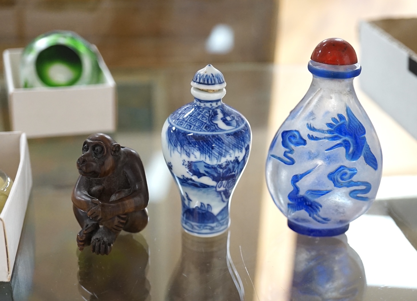 Fourteen Chinese snuff bottles, mostly glass and two netsukes including one in the form of a monkey, signed, largest 7.5cm high. Condition - varies, poor to good